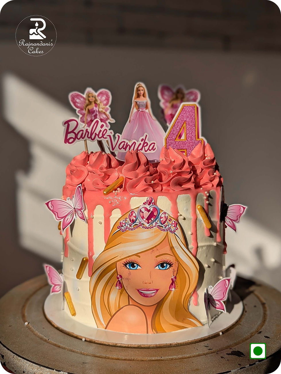 Pink fairy Barbie princess birthday cake with glitter age topper and piped swirls by Rajnandani Cakes in Pune.