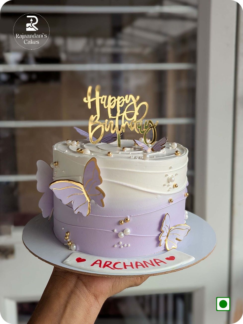 Custom dual-tone lavender and white birthday cake ombre effect decorated with paper butterflies by Rajnandani's Cakes.