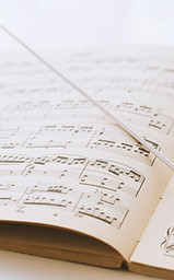 Conductor's baton on sheet music
