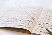 Conductor's baton on sheet music