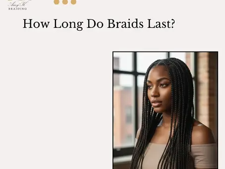Woman with fresh knotless braids at a professional braiding salon.