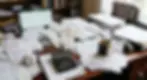 Disorganized financial records and paperwork on a business desk.
