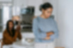 A woman looking sad and stressed after a kitchen argument, reflecting emotional overload and its impact on intimacy in Psychologist/Therapist, Relationship Therapy, and Couples Therapy work in Orange County.