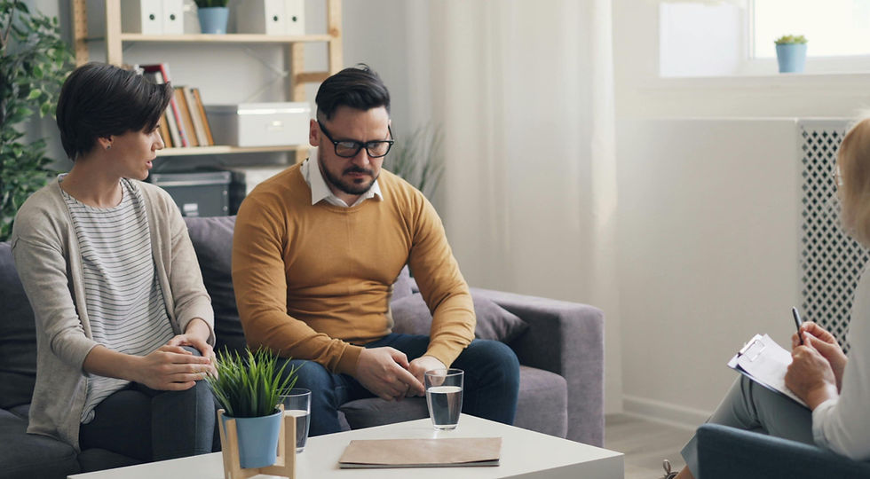 A couple sitting together in a therapist’s office during a session, reflecting communication and relational healing often explored in Psychologist/Therapist, Relationship Therapy, and Couples Therapy in Orange County.