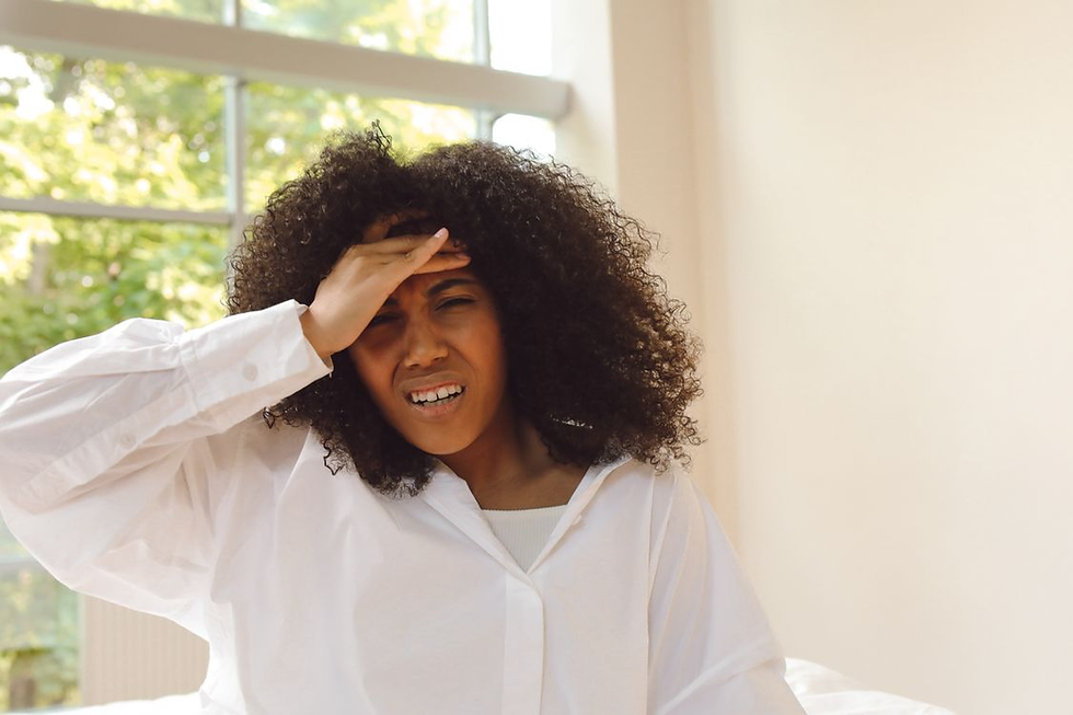 Woman experiencing nausea, dizziness, and a headache, illustrating potential medication side effects discussed in evidence-based sex therapy and sexual health counseling in Orange County.