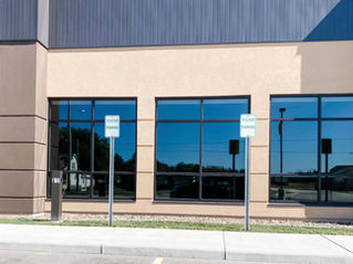 Modern commercial building featuring a storefront glass system with aluminum framing and clear vision glass panels, ideal for energy efficiency and professional curb appeal.