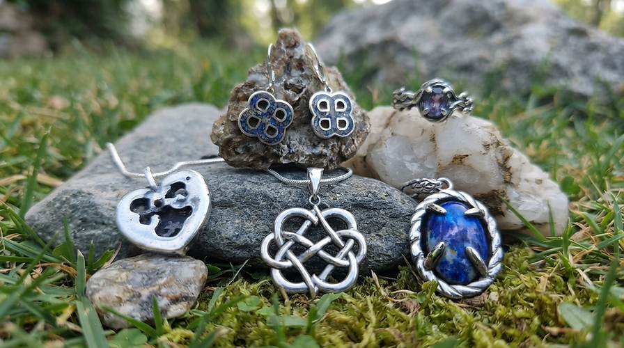 Silver Celtic knot necklaces and jewelry on mossy stones