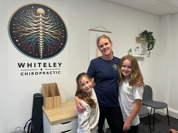 Whiteley Chiropractor stands with two happy patients