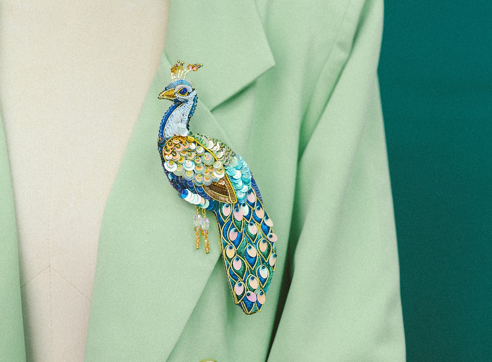 Handmade colorful peacock brooch with blue and yellow accents from Gaia Collection by Laudanda Dea, bold artistic design