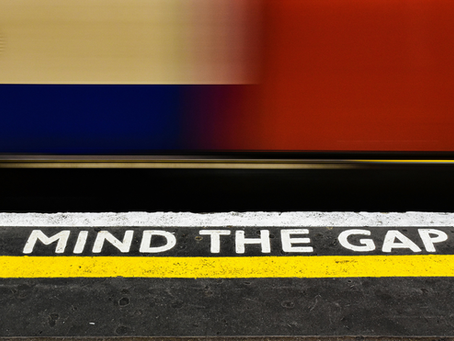 A photo of the edge of an underground platform reading: Mind the Gap