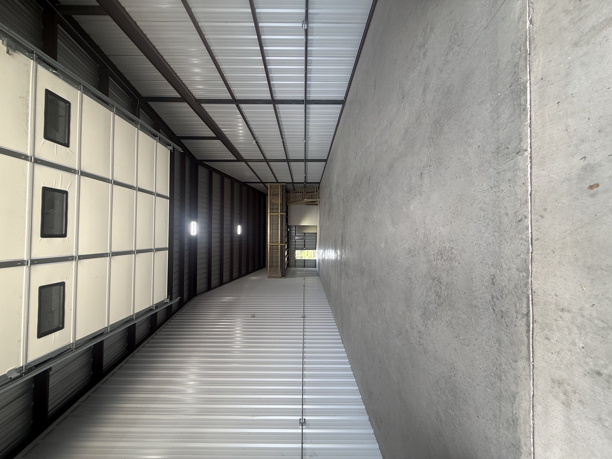 A sleek and modern architectural rendering of the new training facility at dusk.