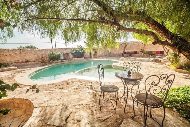 villa pool with table and chairs