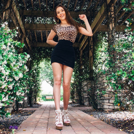 Shoedazzle influencer campaign featuring Madison Masterson. Madison is shown wearing tan strappy heals from Shoedazzle, a black skirt, and a cheetah print shirt.