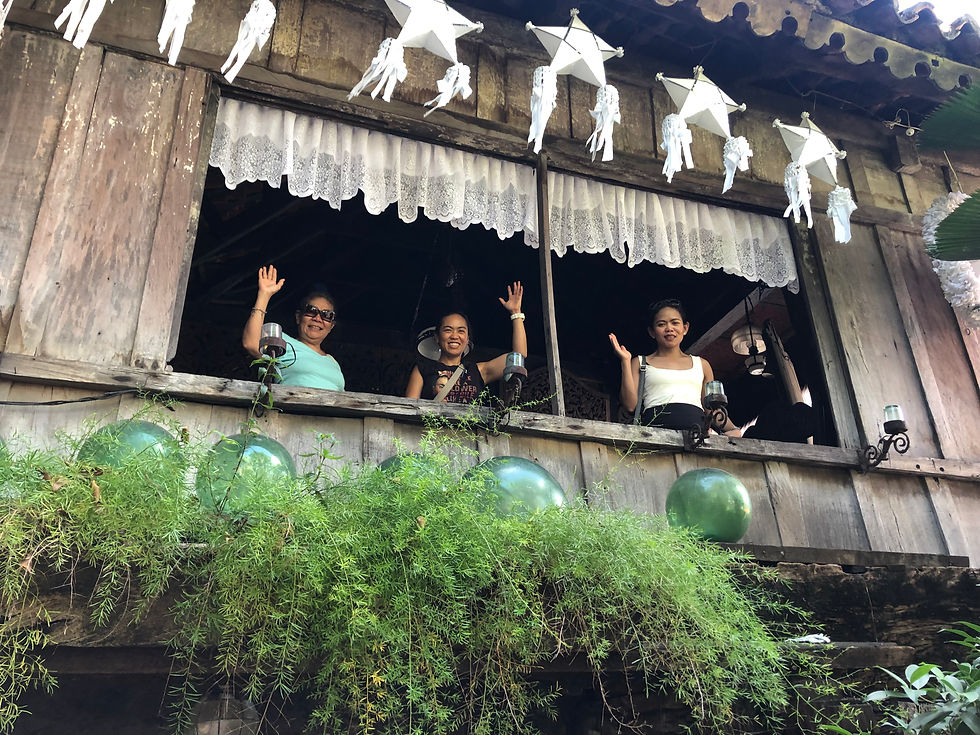 Waving from the window of the Yap San Diego House