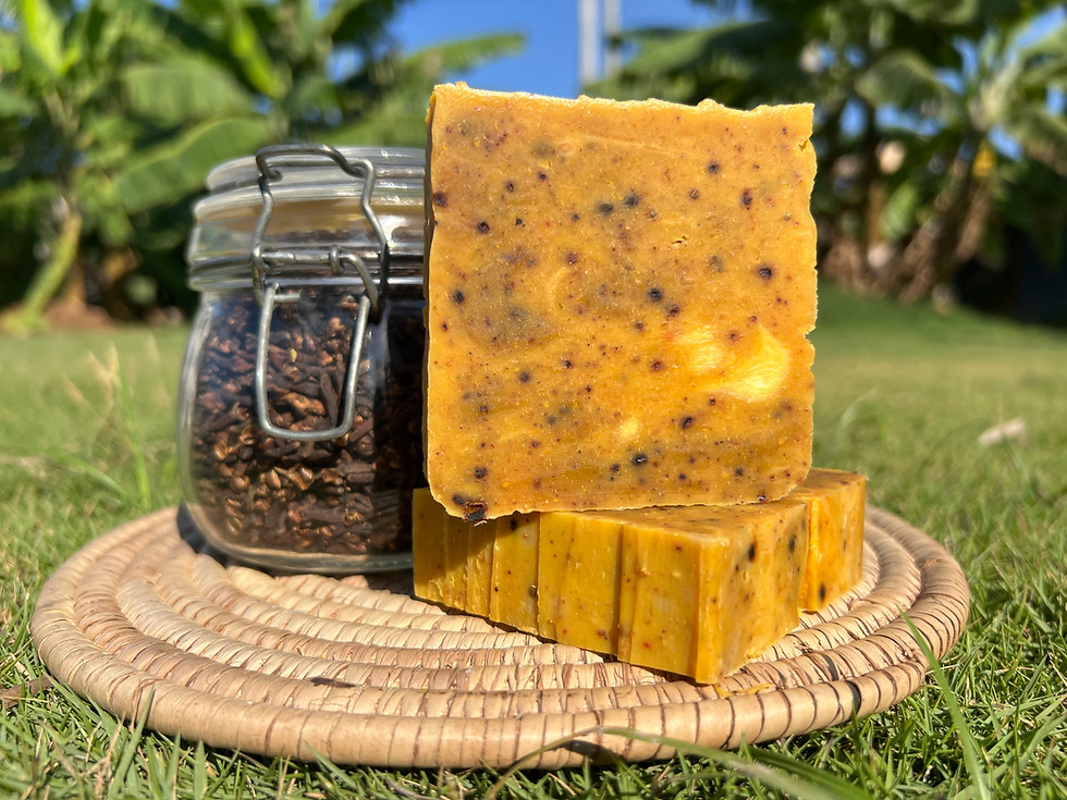 Stacked Rice, Shea Butter & Coconut soap bars with jar of seeds on a woven mat.