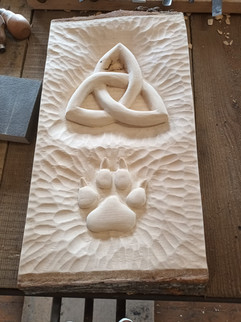 Celtic knot and paw print wood carving