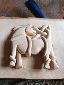 Intricate wood carving of two horses
