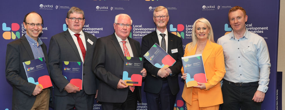 Six people holding award booklets at the LOM Annual Conference