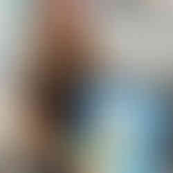 Smiling girl proudly displays her pastel duck painting