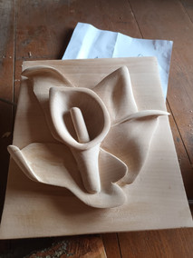 Intricate wood carving of a calla lily