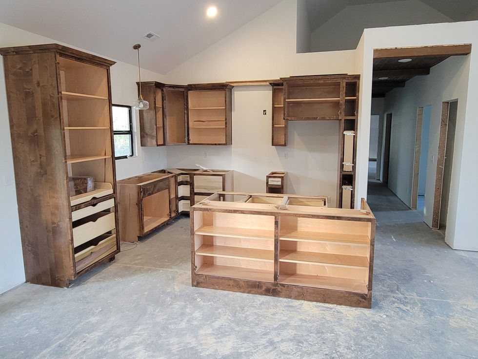 Unfinished kitchen cabinets in a modern kitchen space.