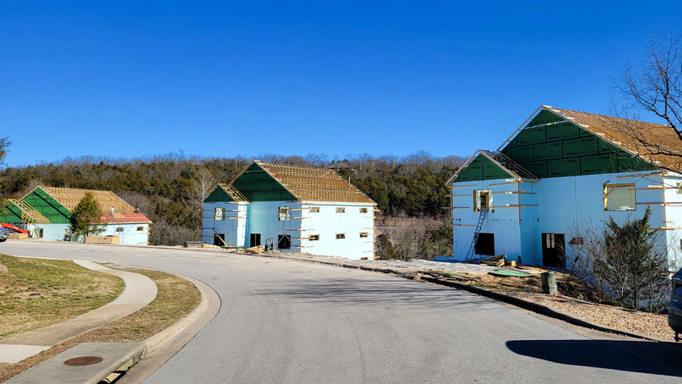 Houses under construction on a clear day.