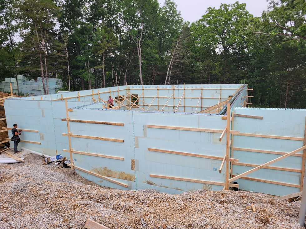 Construction site with wooden framework and blue panels.