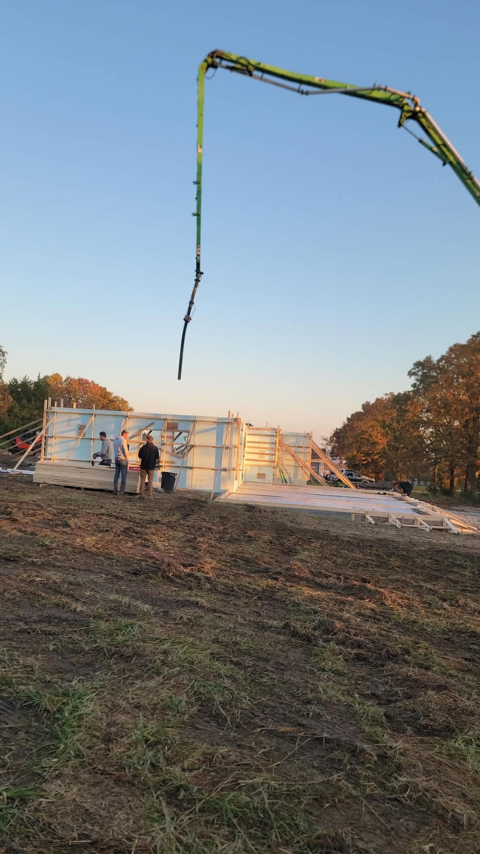 Construction site with workers and building framework.