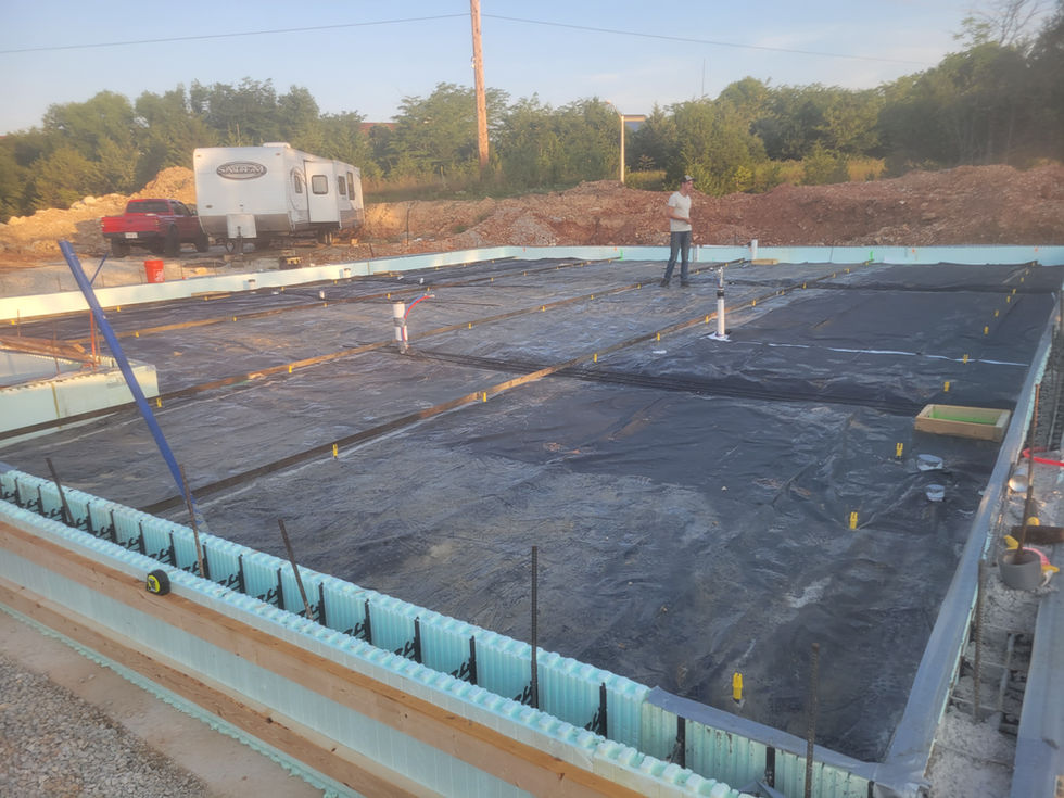 Construction site with foundation and insulation visible.