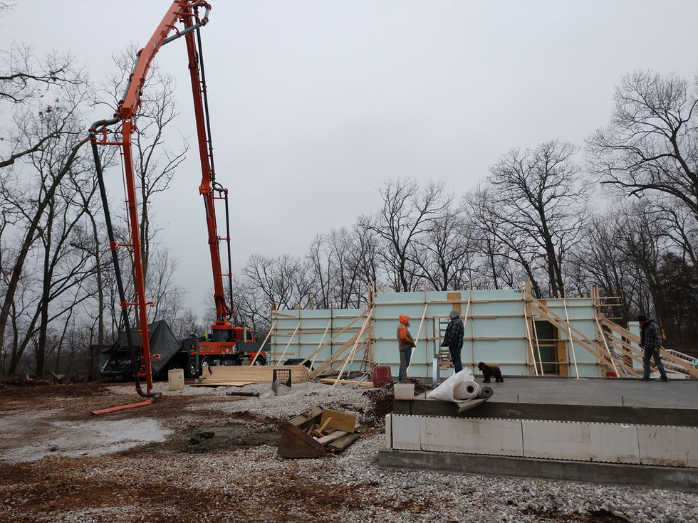 Construction site with crane and workers in winter.
