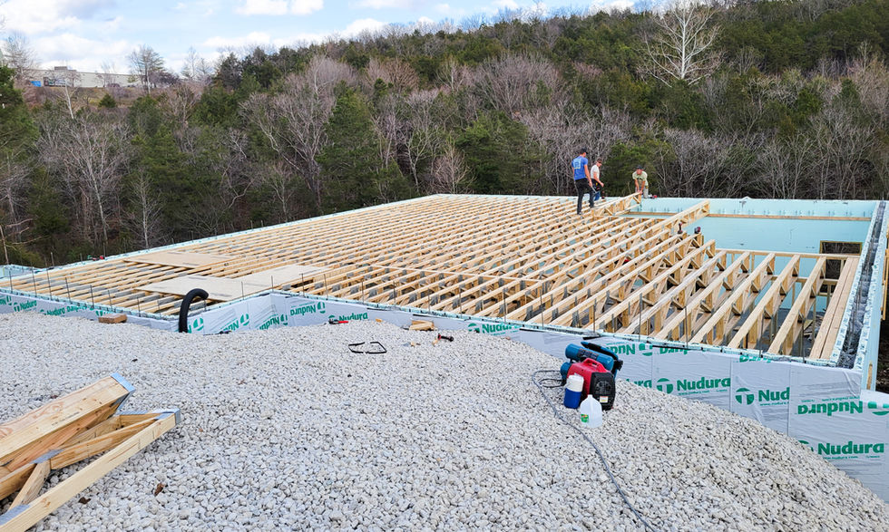 Construction site with workers on wooden framework.