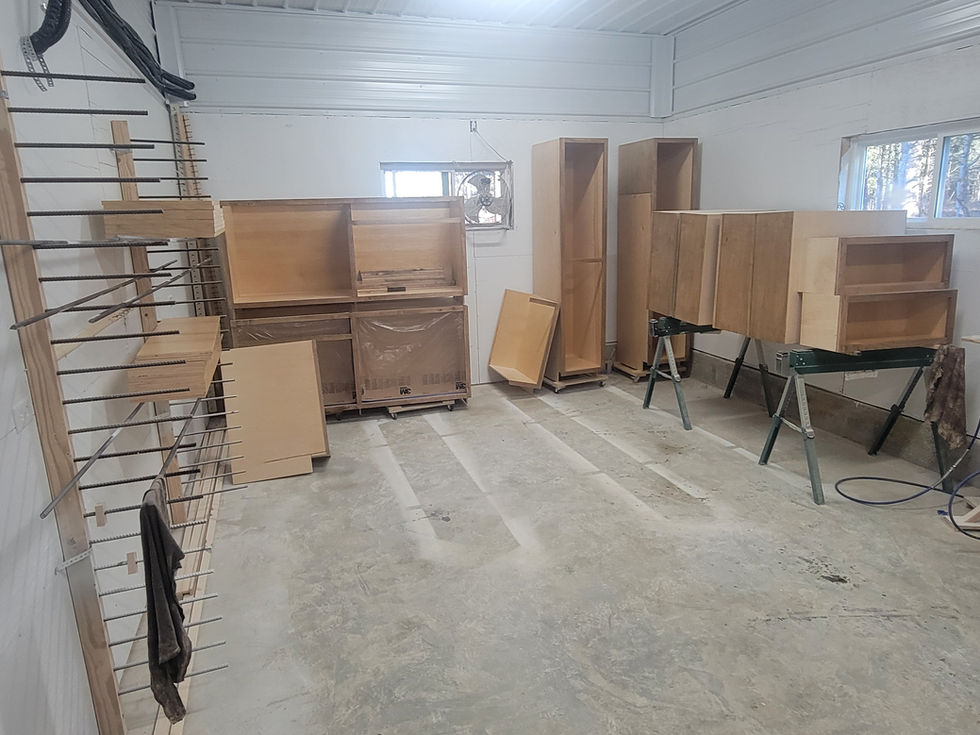 Workshop with wooden cabinets and shelves under construction.