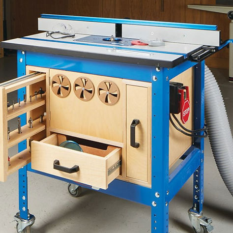 Router table with adjustable fence and safety guard in a well-organized woodworking workshop