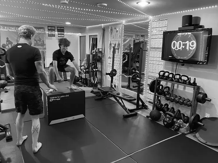 Client performing a box jump for functional training at J Fitness and Training