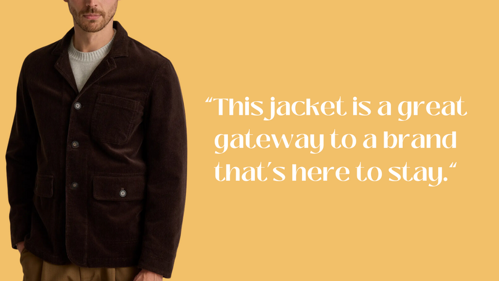 Person wearing a dark brown jacket with a light-colored sweater underneath and light brown pants. Text: "This jacket is a great gateway to a brand that's here to stay." Color: Espresso. Background: light orange.