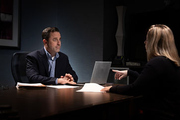 male lawyer and female client conference room deposition action shot