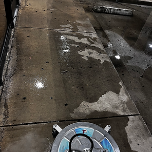 Split contrast shot showing a dirty concrete surface next to a clean power-washed side