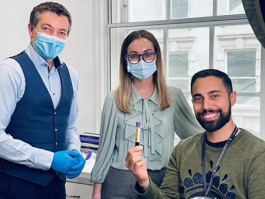 aesthetic doctors with a happy client holding a blood sample