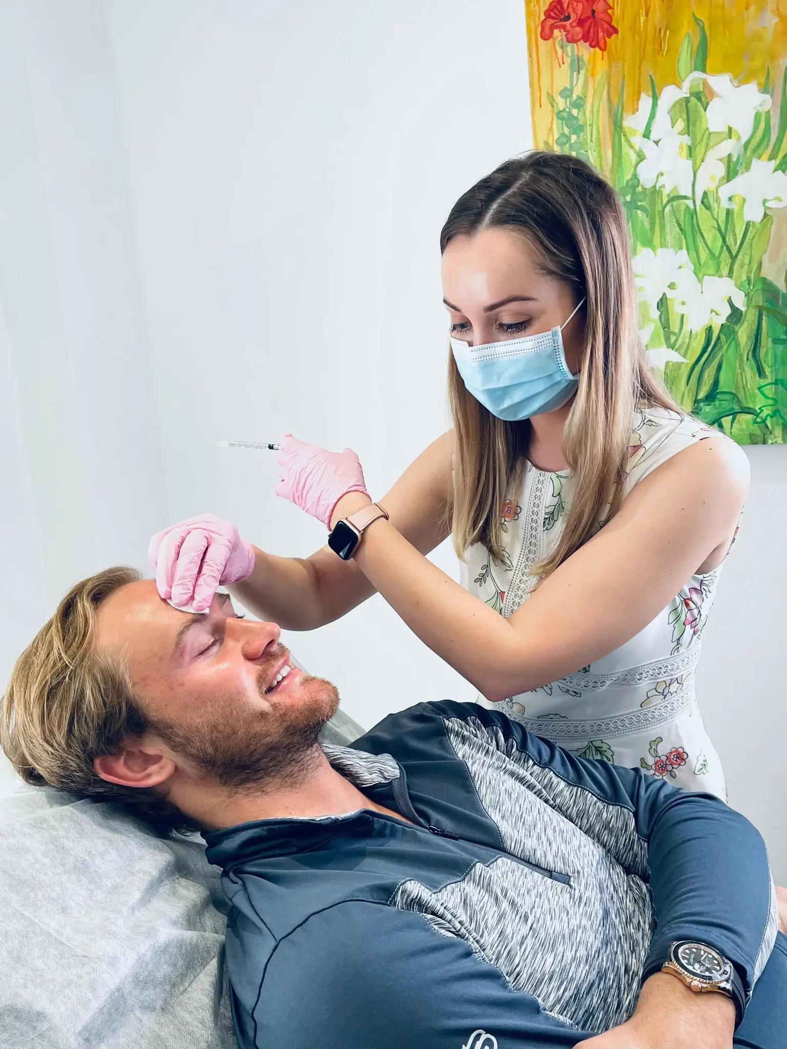 young doctor performs men botox on a young male patient at skinoza clinic