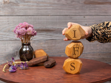 Letters IFS written on wooden irregular blocks. Internal Family Systems psychotherapy treatment concept. internal family systems. inner child work. parts work.