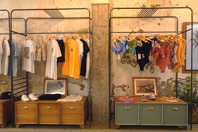 Sistema de exposición de ropa para tienda de surf fabricado en acero y madera