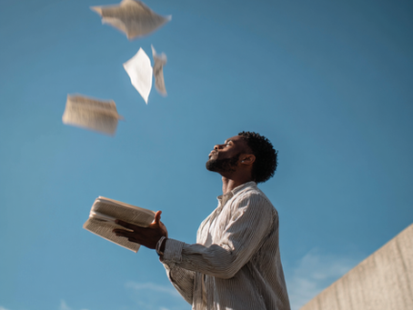 Man throwing script pages into the air outdoors, symbolizing letting go of old sexual conditioning and beginning porn addiction recovery.