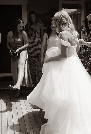 bride and bridesmaids showing each other their heels