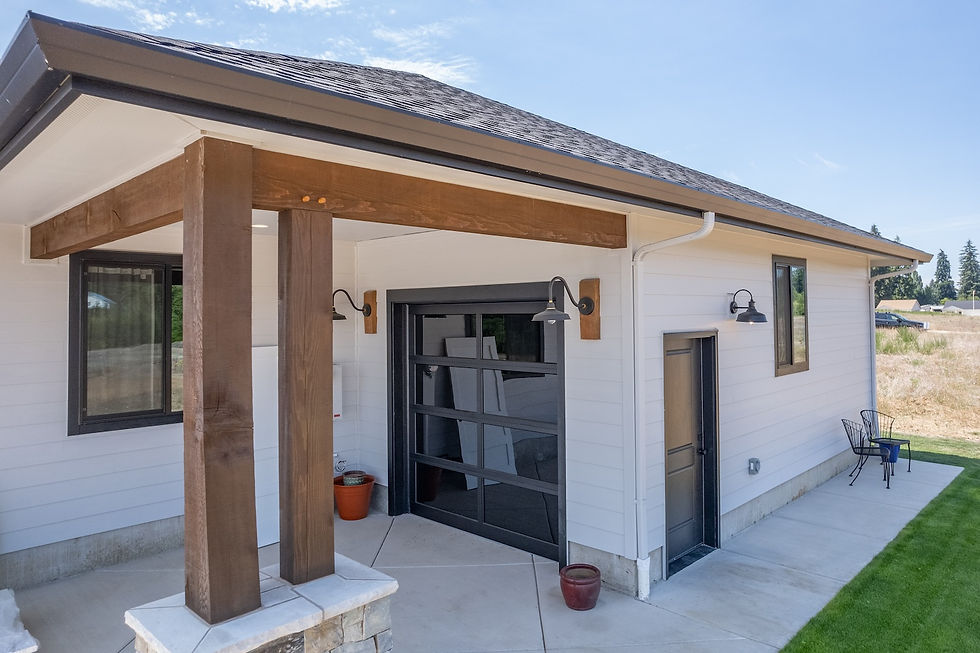 Placement of post & beam elements is chosen by a holistic design approach, where the best visual impact can be made to compliment the entire design. Here, the garage door received an extension of roof cover with a double post and stone securing the structural and visual cohesion of this additional roof coverage.