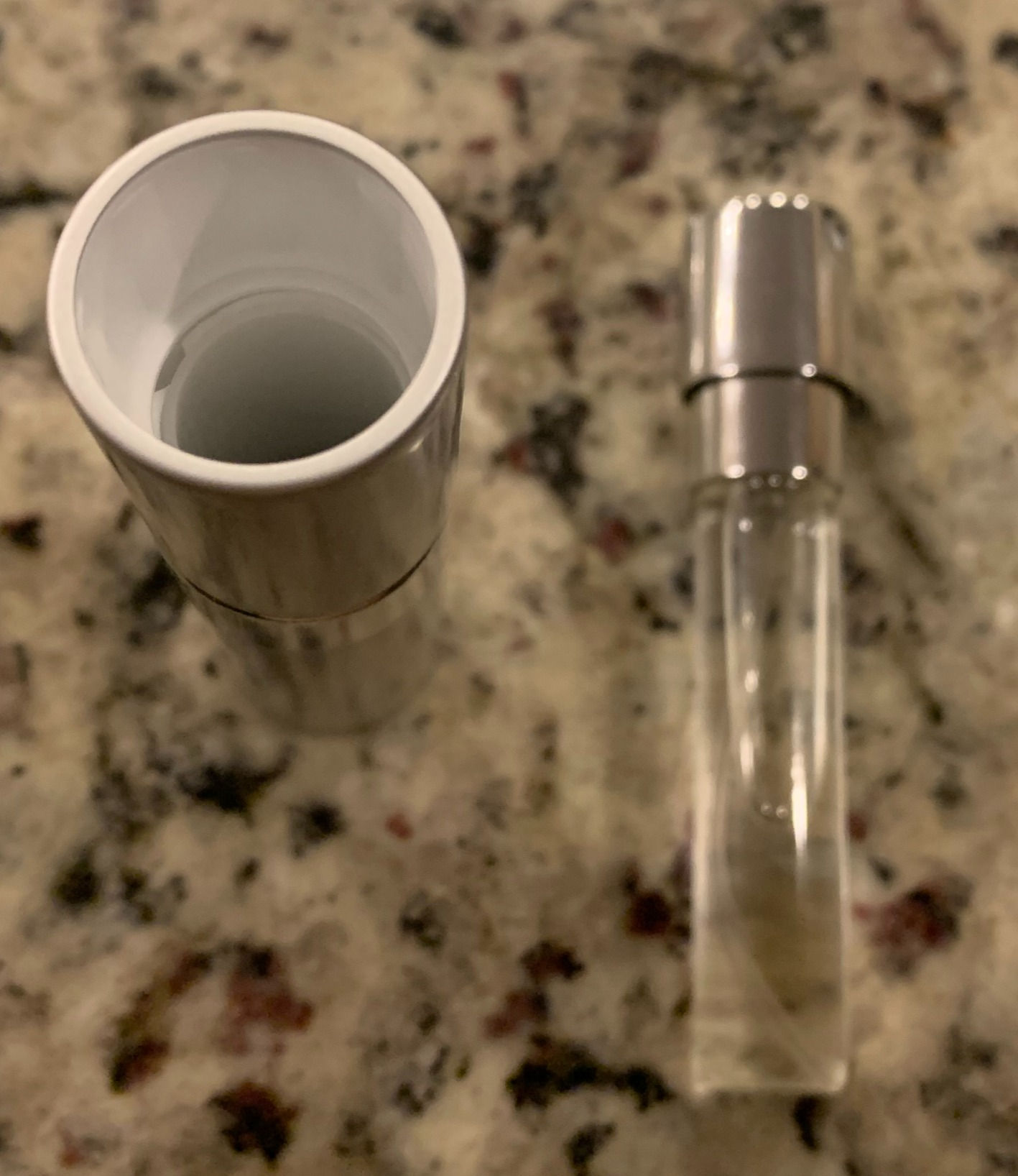 Refillable spray bottle outside of twist holder