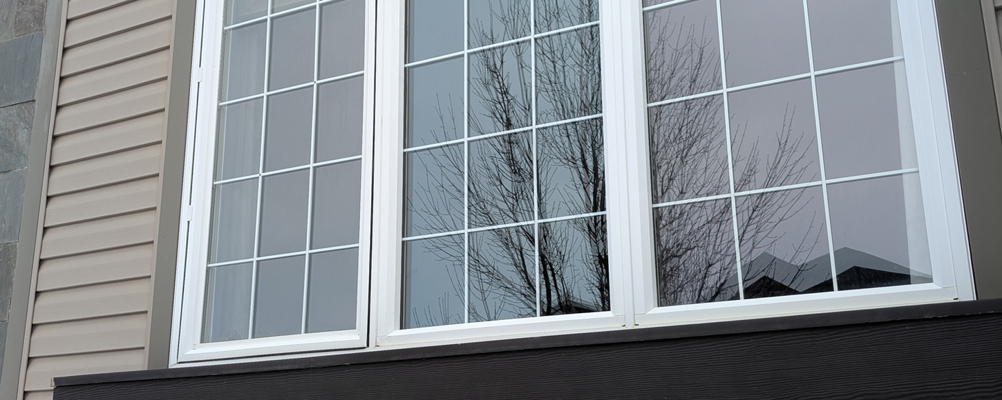 Exterior photo of a window glass replacement project in Regina, Saskatchewan by B-Flex Services.
