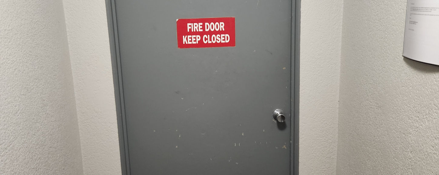 Interior photo of a commercial fire rated steel door installation in Regina, Saskatchewan by B-Flex Services.