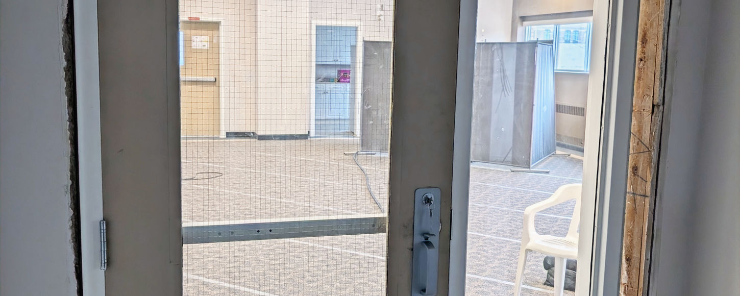 Interior photo of a commercial door with push bar in Regina, Saskatchewan installed by B-Flex Services.