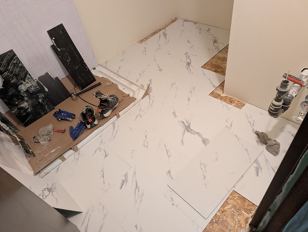 Bathroom renovation in Regina, new tile floor installation.