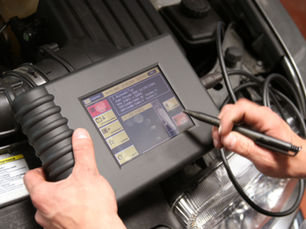 Diagnostic test kit being used to check a car